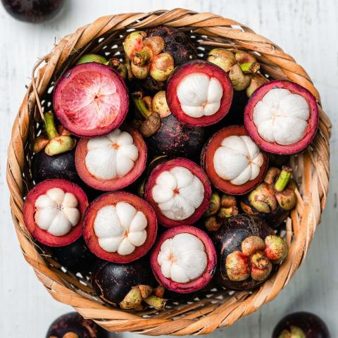 Basket full of mangosteen (Garcinia mangostana), Colombia traditional fruit.